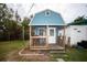 Charming guest house with a porch and white door at 8742 Narcissus Ave, Seminole, FL 33777