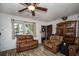 Living room with brown leather furniture and wood-look floors at 8742 Narcissus Ave, Seminole, FL 33777