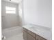 Bathroom with tub, vanity, and marble floor at 9032 Evelyn Rd, Englewood, FL 34224