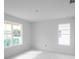 Unfinished bedroom with large windows and marble floors at 9032 Evelyn Rd, Englewood, FL 34224