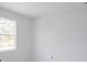 Simple bedroom with large window and white walls at 9032 Evelyn Rd, Englewood, FL 34224