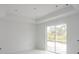 Unfinished bedroom with sliding glass doors and marble floors at 9032 Evelyn Rd, Englewood, FL 34224