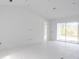 Bright living room with sliding glass doors and marble floors at 9032 Evelyn Rd, Englewood, FL 34224