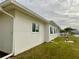 Side view of house with white exterior and lawn at 9920 34Th N Way, Pinellas Park, FL 33782