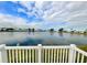 Stunning lakefront view from a deck with a white railing at 9920 34Th N Way, Pinellas Park, FL 33782