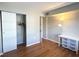 Bedroom with closet, hardwood floors, and simple furnishings at 100 Waverly Way # 201, Clearwater, FL 33756