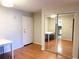 Entryway with hardwood floors, white door, and mirrored closet at 100 Waverly Way # 201, Clearwater, FL 33756