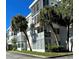 Exterior view of a mid-century modern condo building with palm trees at 100 Waverly Way # 201, Clearwater, FL 33756