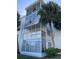 Building exterior showcasing a balcony and surrounding trees at 100 Waverly Way # 201, Clearwater, FL 33756