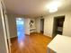 Living area with hardwood floors, white table, and mirrored closet at 100 Waverly Way # 201, Clearwater, FL 33756