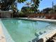 Inviting rectangular swimming pool with lounge chairs and surrounding foliage at 100 Waverly Way # 201, Clearwater, FL 33756