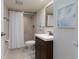 Clean bathroom with a shower/tub combo and dark vanity at 10355 Paradise Blvd # 212, Treasure Island, FL 33706