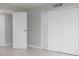 Bedroom with tile floors, white doors and neutral walls at 10355 Paradise Blvd # 212, Treasure Island, FL 33706