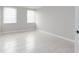 Simple bedroom with tile floors and two windows at 10355 Paradise Blvd # 212, Treasure Island, FL 33706