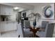 Modern dining area with glass table and four grey chairs at 10355 Paradise Blvd # 212, Treasure Island, FL 33706