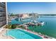Inviting pool area with marina views and ample deck space at 10355 Paradise Blvd # 212, Treasure Island, FL 33706