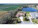 Aerial view of a home with pool, situated on a large lot near a lake and farmland at 10929 Brooksnest Ct, Lithia, FL 33547