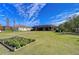 Landscaped backyard with a raised garden bed at 10929 Brooksnest Ct, Lithia, FL 33547
