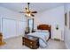 Bedroom with ceiling fan and wooden bed frame at 10929 Brooksnest Ct, Lithia, FL 33547