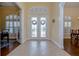 Bright and airy entryway with double doors and tile flooring at 10929 Brooksnest Ct, Lithia, FL 33547