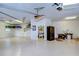 Large garage with overhead storage and workshop area at 10929 Brooksnest Ct, Lithia, FL 33547