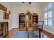 Home office with built-in shelving and hardwood floors at 10929 Brooksnest Ct, Lithia, FL 33547