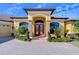 Elegant house entrance with double doors and landscaping at 10929 Brooksnest Ct, Lithia, FL 33547