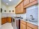 Laundry room with ample cabinetry and granite countertop at 10929 Brooksnest Ct, Lithia, FL 33547