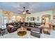 Spacious living room featuring a large sectional sofa and a view into the kitchen at 10929 Brooksnest Ct, Lithia, FL 33547