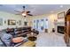 Living room with a fireplace, large sectional sofa and access to a backyard patio at 10929 Brooksnest Ct, Lithia, FL 33547