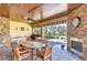 Covered patio with dining table, fireplace, and built-in grill at 10929 Brooksnest Ct, Lithia, FL 33547