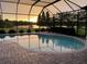 Relaxing pool with sunset view and screened enclosure at 10929 Brooksnest Ct, Lithia, FL 33547