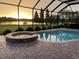 Stunning sunset view from screened pool and spa at 10929 Brooksnest Ct, Lithia, FL 33547