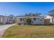 Newly renovated home with a well-manicured lawn and wooden fence at 1234 29Th N St, St Petersburg, FL 33713