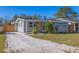 Well-maintained home with a spacious driveway and mature landscaping at 1234 29Th N St, St Petersburg, FL 33713