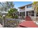 Home's back features a deck, screened porch, and steps to the water at 13477 Irwin Dr, Port Charlotte, FL 33953