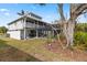 House exterior with a large backyard and partial pool view at 13477 Irwin Dr, Port Charlotte, FL 33953