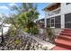 Steps leading to a screened porch and deck overlooking the water at 13477 Irwin Dr, Port Charlotte, FL 33953
