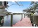 Red wooden dock extending into the waterway at 13477 Irwin Dr, Port Charlotte, FL 33953