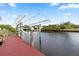 Covered boat dock with lift provides easy water access at 13477 Irwin Dr, Port Charlotte, FL 33953