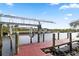 Wooden dock with a boat lift, offering convenient water access at 13477 Irwin Dr, Port Charlotte, FL 33953