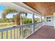 Relaxing deck overlooking backyard with wooden flooring and white railings at 13477 Irwin Dr, Port Charlotte, FL 33953