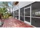 Red wooden deck with access to a screened patio at 13477 Irwin Dr, Port Charlotte, FL 33953