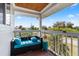 Covered deck with teal couch and beautiful view at 13477 Irwin Dr, Port Charlotte, FL 33953