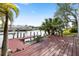 Red wooden dock with seating overlooking the water at 13477 Irwin Dr, Port Charlotte, FL 33953