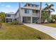 Two-story home with covered porch and palm trees at 13477 Irwin Dr, Port Charlotte, FL 33953