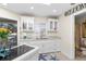 Modern white kitchen with granite counters and built-in seating at 13477 Irwin Dr, Port Charlotte, FL 33953