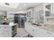 Open concept kitchen with island and access to outdoor deck at 13477 Irwin Dr, Port Charlotte, FL 33953