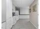White kitchen with ample cabinetry and tile flooring at 13477 Irwin Dr, Port Charlotte, FL 33953