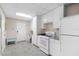 White kitchen with stainless steel appliances and tile floor at 13477 Irwin Dr, Port Charlotte, FL 33953